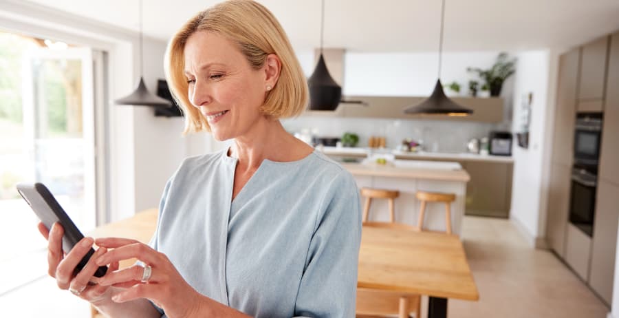Woman using a mobile device in a modern home